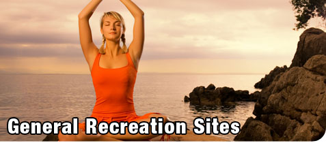 General Recreation. Beautiful Blonde Woman doing Yoga on a Cliff by the Ocean